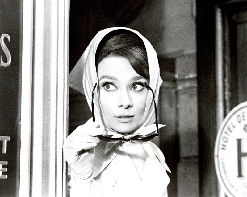 Audrey Hepburn wears head scarf.