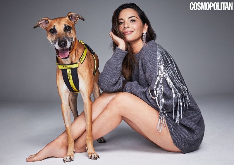 Posing with a dog, Olivia Munn wears fringed sweater