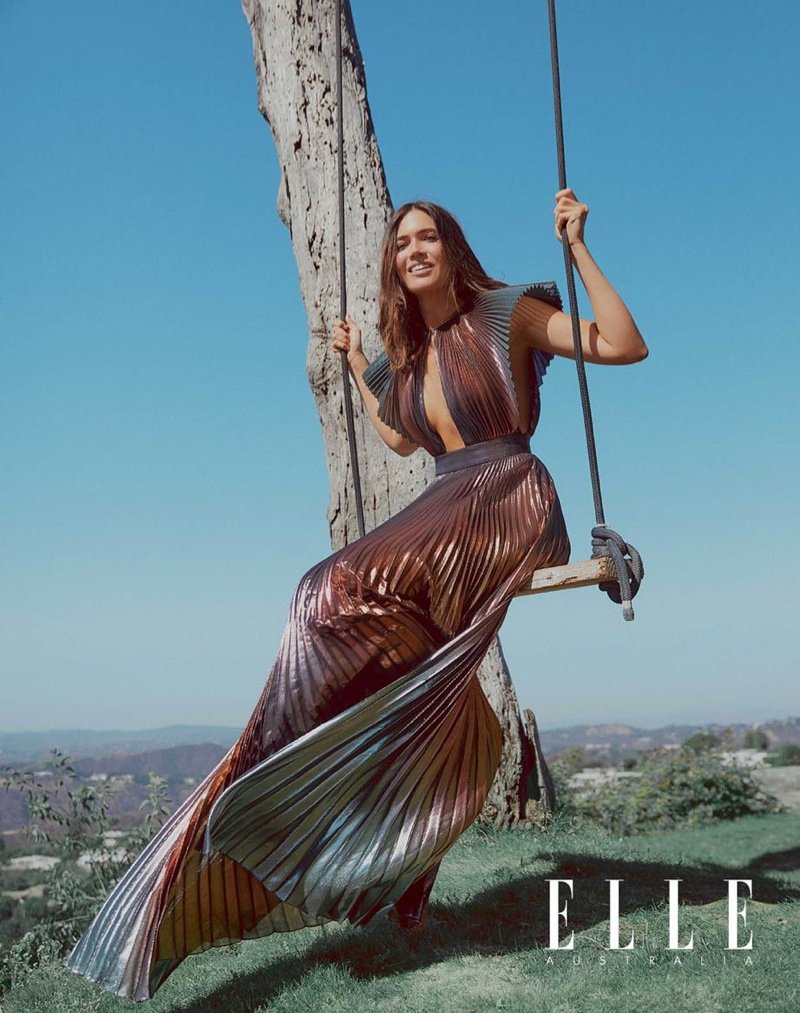 Sitting on a swing, Mandy Moore poses in a pleated Givenchy gown